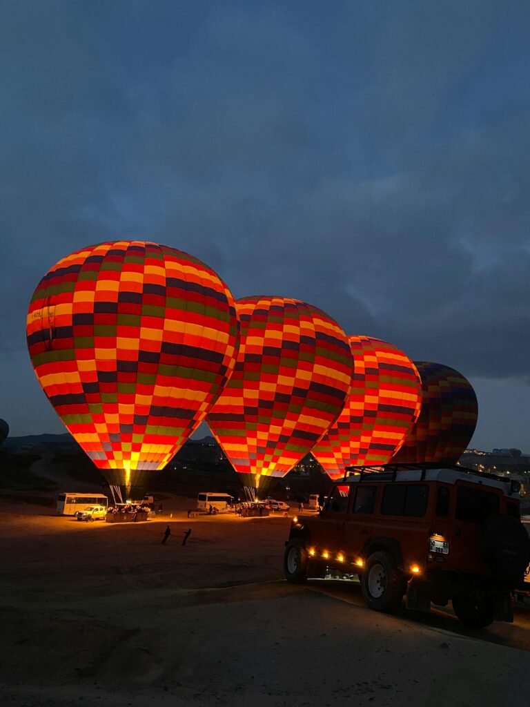pexels-photo-30591316-30591316 Glowing hot air balloons ready for takeoff at night in Cappadocia's serene landscape.