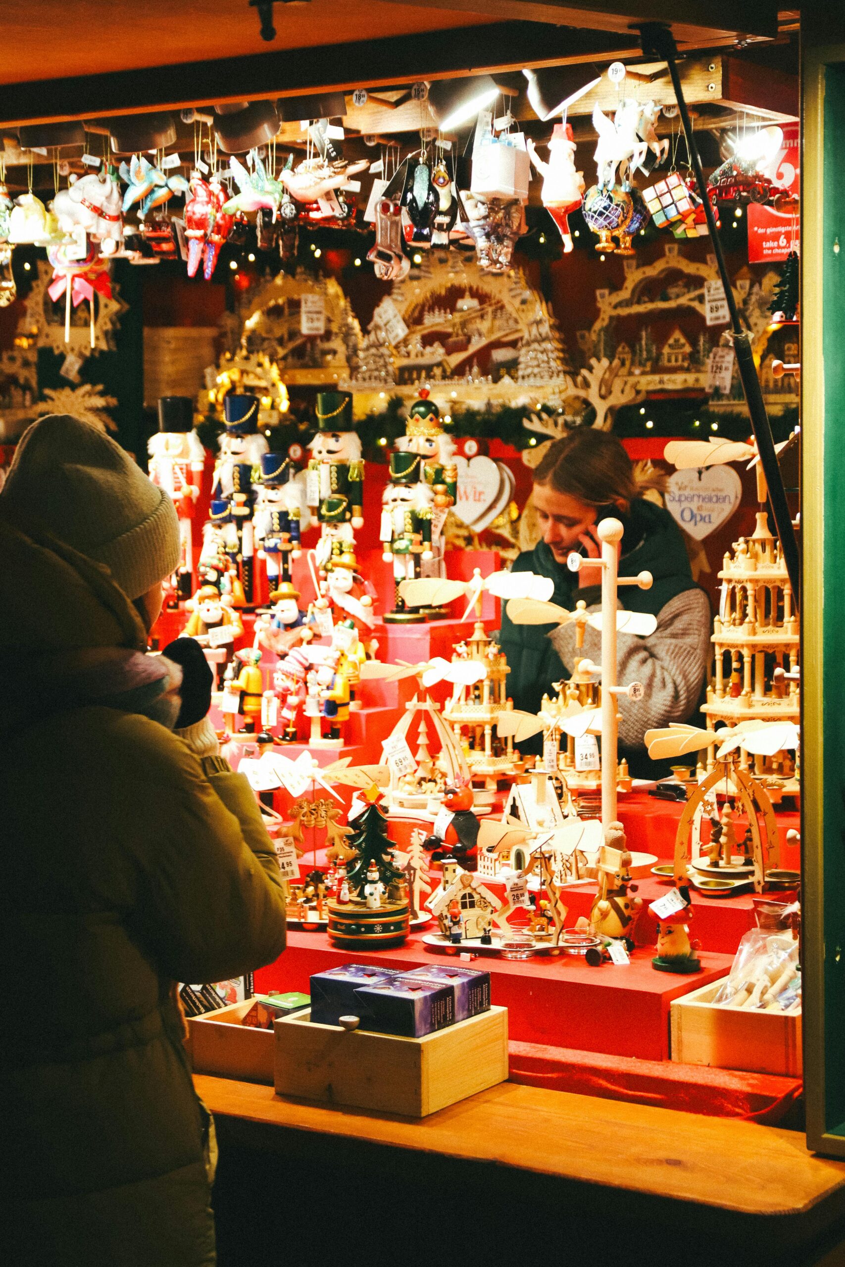 Explore a vibrant Christmas market in Berlin with handcrafted ornaments and festive decorations on display.